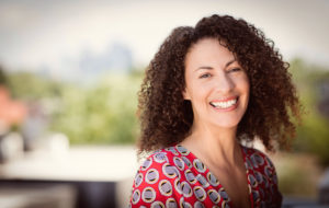 A girl is smiling. She is feeling happy since starting anxiety therapy in San Diego, CA with Headway Therapy 92024.