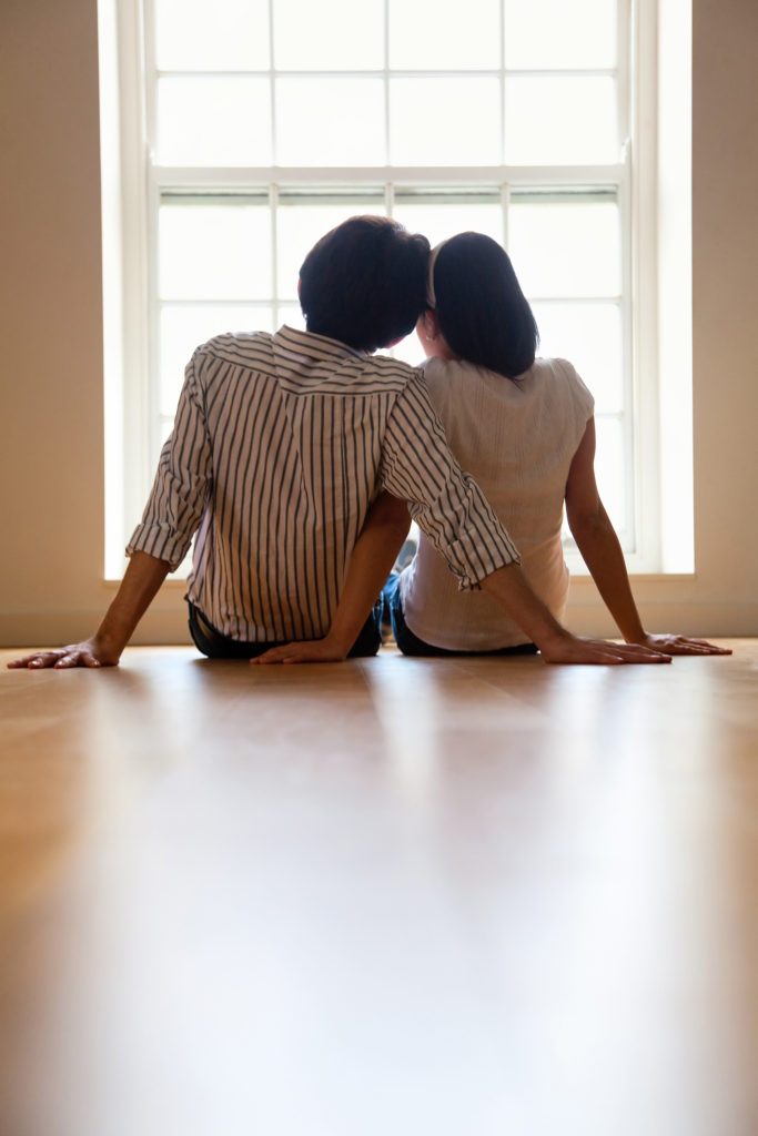couple looking outside and dreaming of an intended family