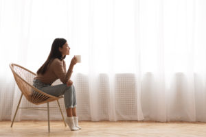 A woman sits in a chair. This reflects concepts of therapy for high achievers in San Diego, CA.